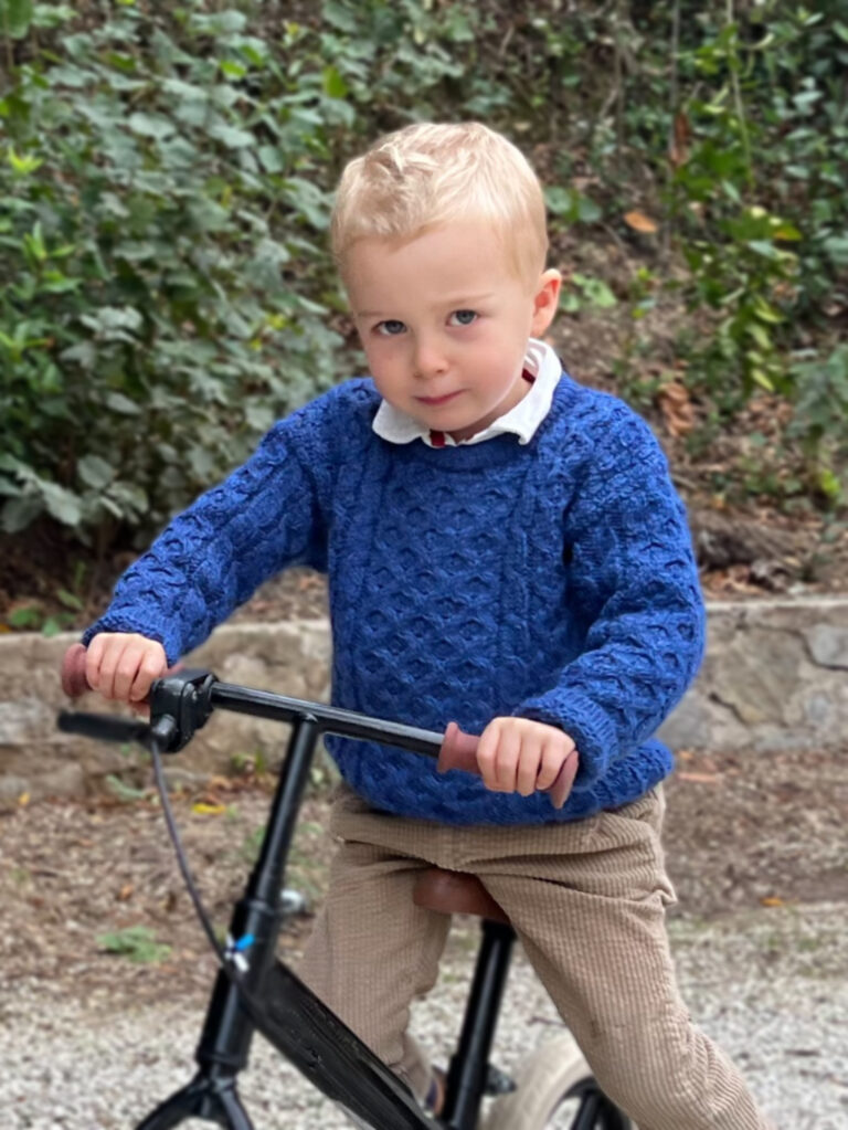 Traditional Irish Blue Merino Wool Crew Neck Baby Sweater Worn by a Child